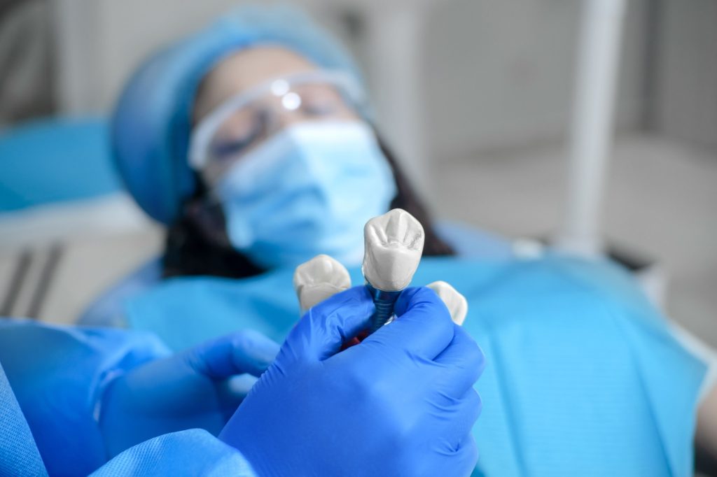 Dentist discussing a dental crown with a patient in Leawood, KS